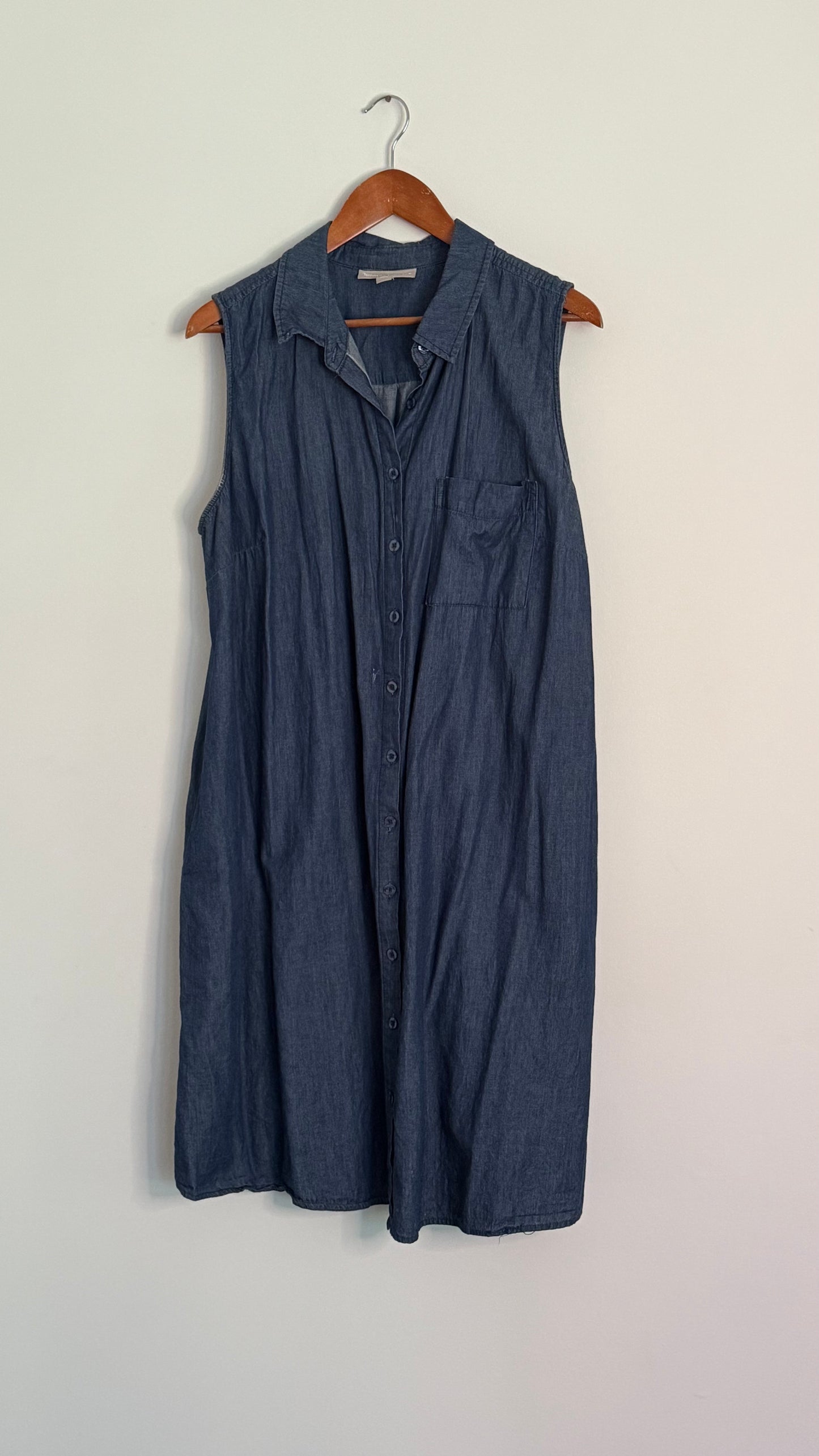 woman within sleeveless bleached denim button up dress