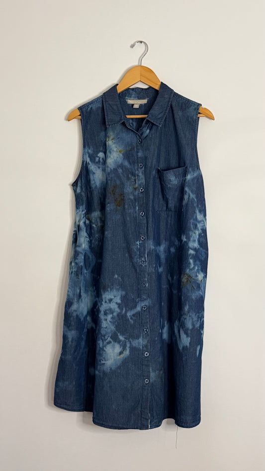 woman within sleeveless bleached denim button up dress